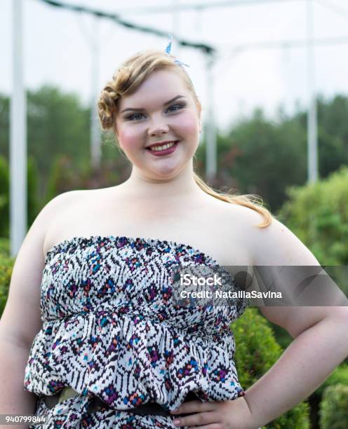 Young Beautiful Plus Size Model Xxl Woman Portrait Against The Background  Of A Blossoming Garden Stock Photo - Download Image Now - iStock