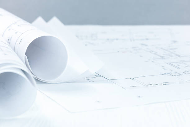 istock architect blueprint rolls and drawing on desk with copy space 940829504