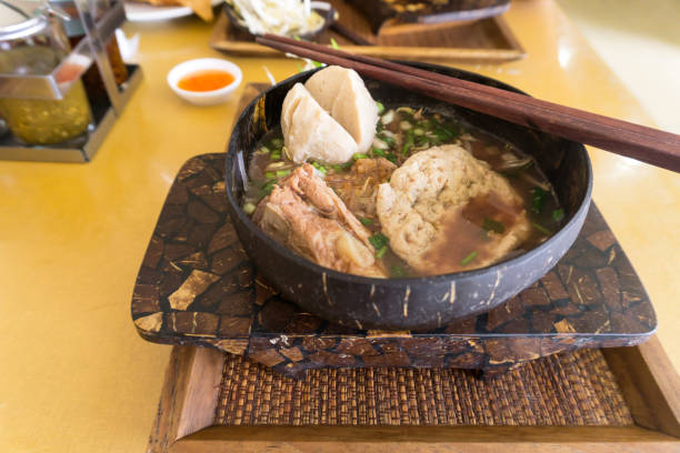 istock Thai Noodle and big meatball in coconut shells as bowl 940832732