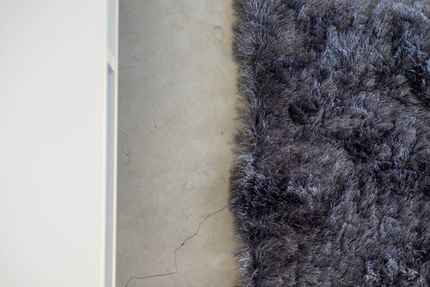 istock Dark gray soft carpet concrete floor from above 940833522