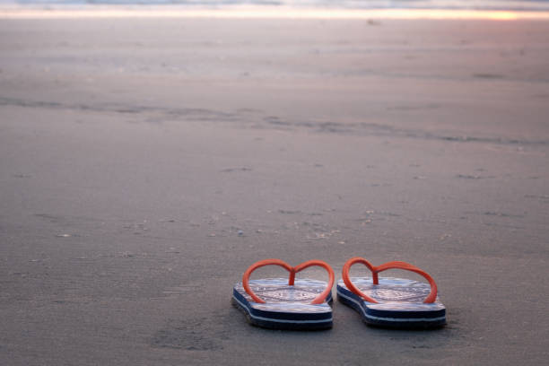 istock Beach sandals on the sandy sea coast 940849206