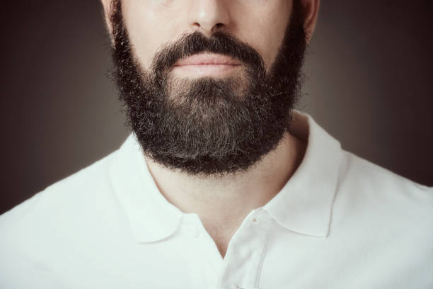 istock Croped image of bearded man over dark background 940852480