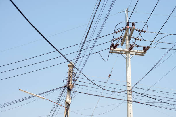 istock High voltage electricity pole in blue sky background. 940855894
