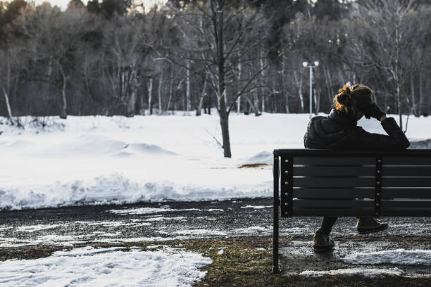 istock Lonely woman thinking on a park bench 940856634