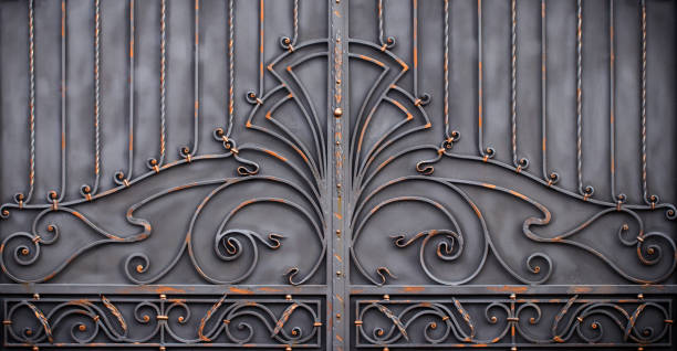 istock magnificent wrought-iron gates, ornamental forging, forged elements close-up 940864398