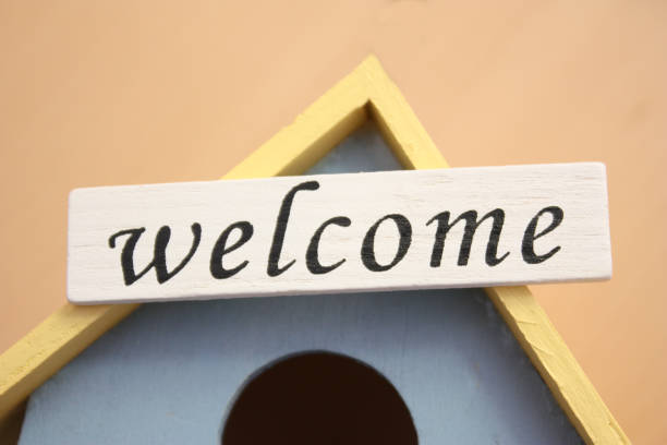 istock wooden bird's nest with a welcome sign 940864850