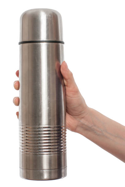 istock hand holding metal thermos isolated on white background 940867946