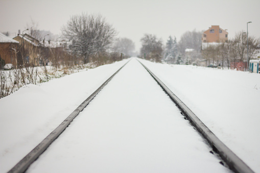 Nice perspective view of railway in snow. Winter landscape with empty rail tracks. Wintertime