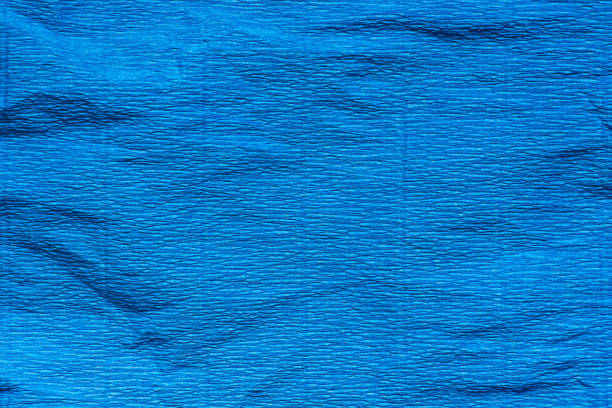 istock blue creased crepe paper background texture 940876990