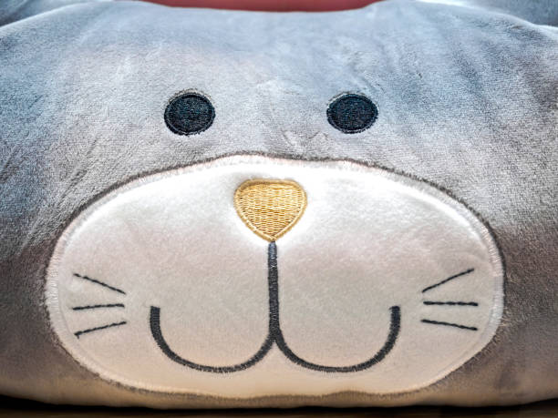istock Closeup of home plush cushion with a smiling cat expression 940880134