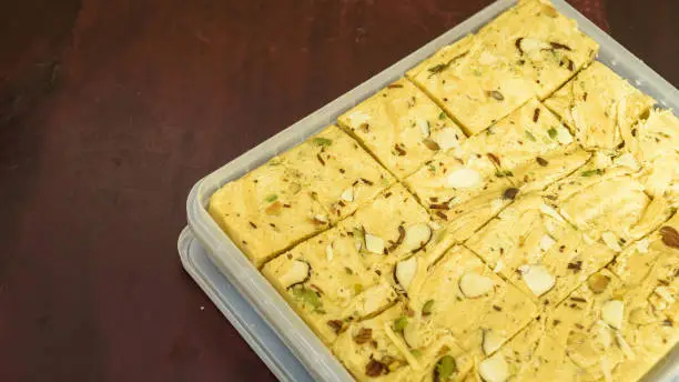 Soan papdi with selective focus and in wooden background.