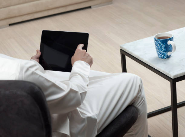 Saudi Arabian Man Using Tablet at Home Environment stock photo