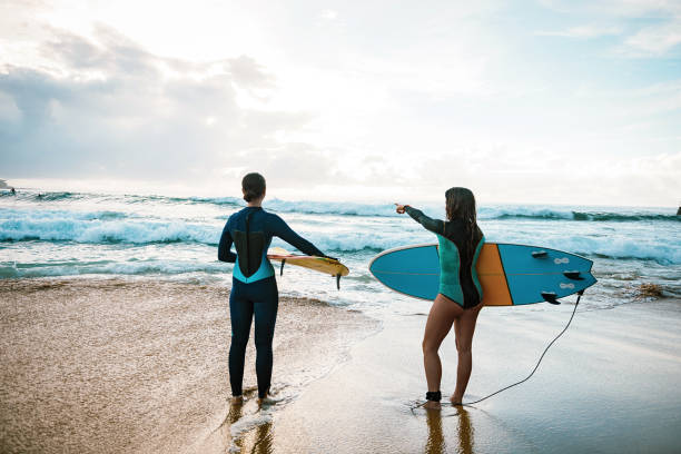 istock Girls going surfing on summer day 940889406