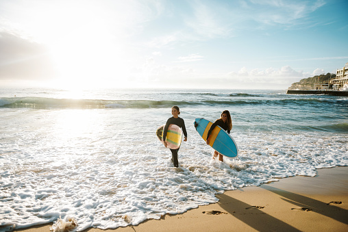 Surfing is a way of living in Australia and young and mature sporty women go surfing every morning.