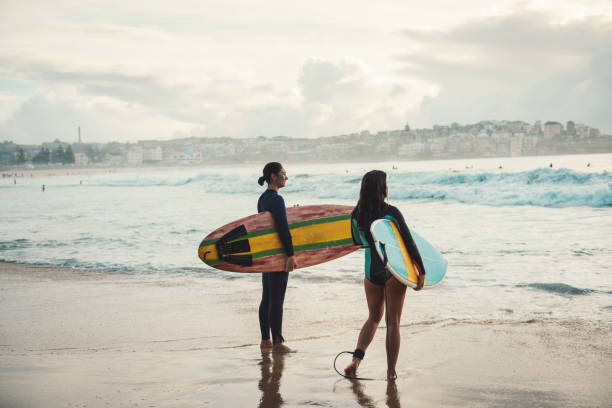 istock Two women going surfing in the morning 940892002