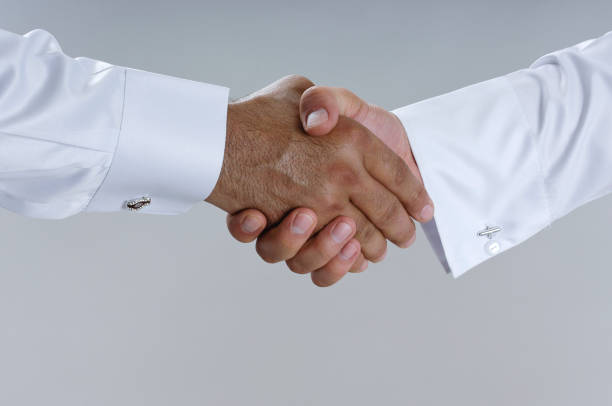 Saudi Arab Businessmen Hands Shaking, Making Agreement and Welcoming Closeup stock photo