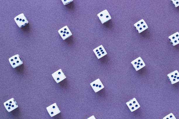 istock Gaming white dice pattern on purple background in flat lay style. 940895346