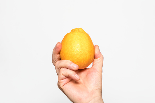 an orange held in one hand