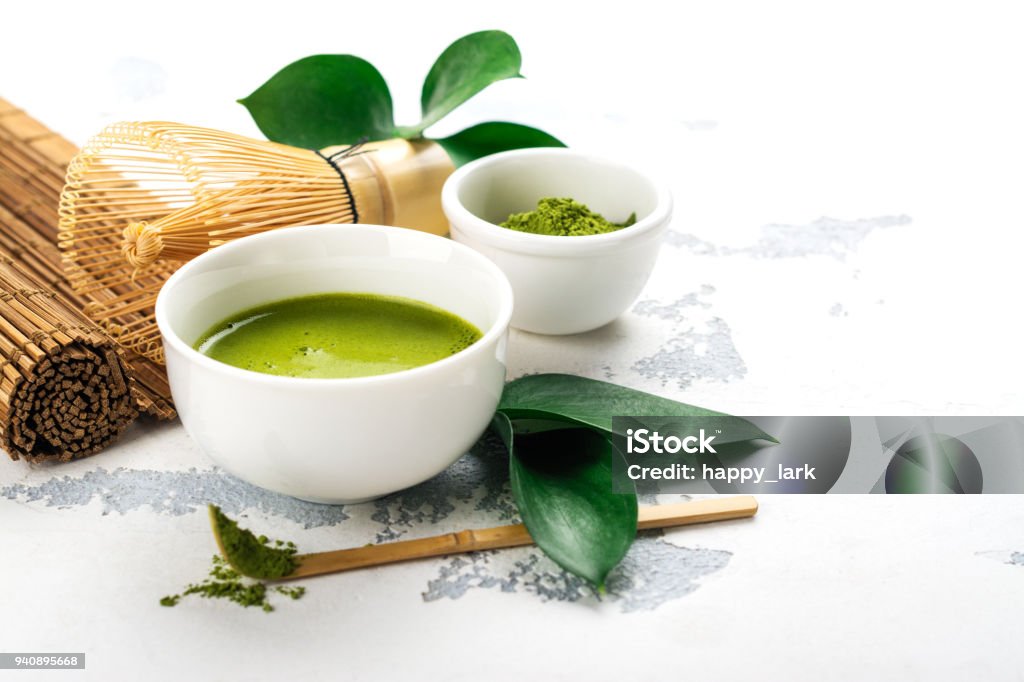 Green matcha tea drink and tea accessories on white background Green matcha tea drink and tea accessories on white background. Japanese tea ceremony concept. Copy space Matcha Tea Stock Photo