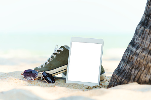close-up digital tablet on the beach