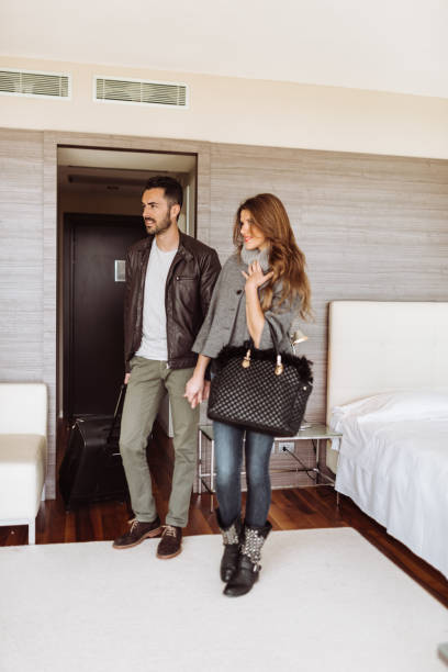 istock couple entering in the hotel room 940898776