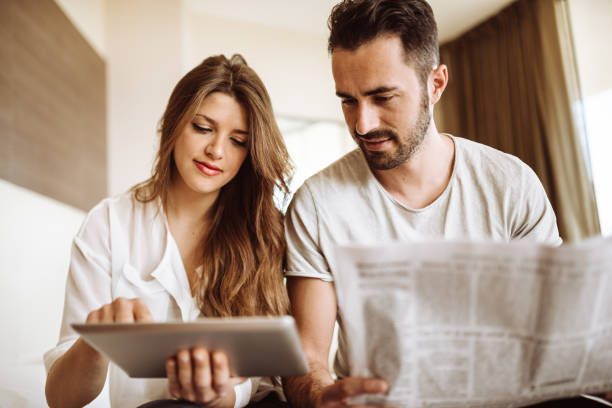 istock couple reading the newspaper on the hotel 940901322