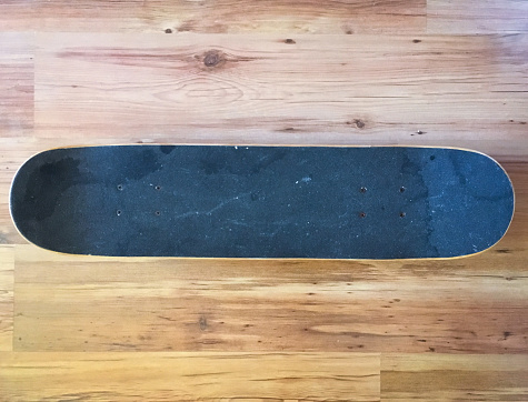 black used skateboard on a light wooden background
