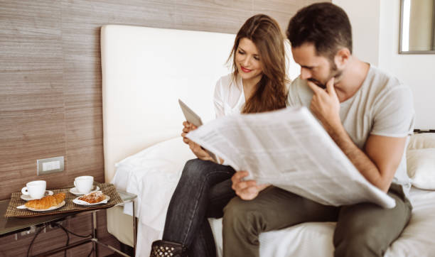 istock couple reading the newspaper on the hotel 940901612