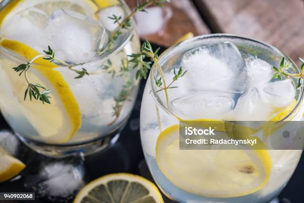 Photo libre de droit de Citron Cocktail De Thym Et De La Glace Sur Fond Rustique Foncé Gros Plan Rafraîchissante Boisson Cocktail Jaune De Lalcoolique banque d'images et plus d'images libres de droit de Gin