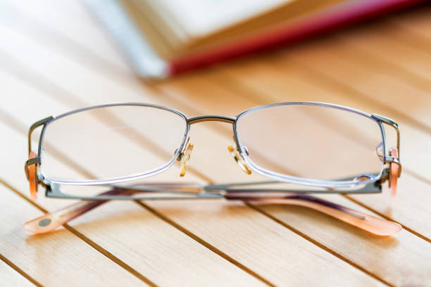 istock Glasses and open book on wooden table close 940902128