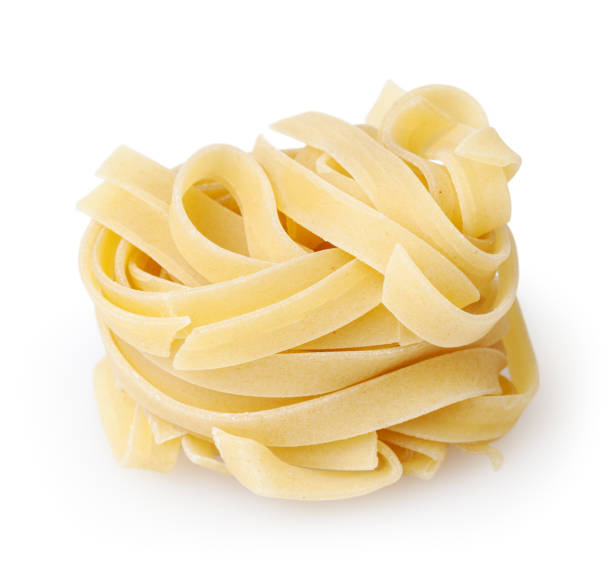 istock Uncooked nest of tagliatelle pasta isolated on white background with clipping path 940904576
