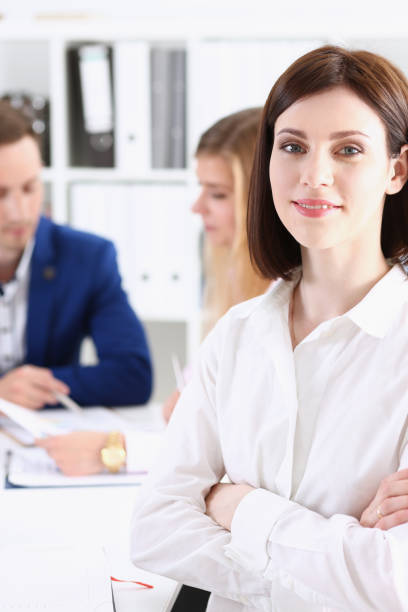 istock Beautiful smiling cheerful girl at workplace 940905718
