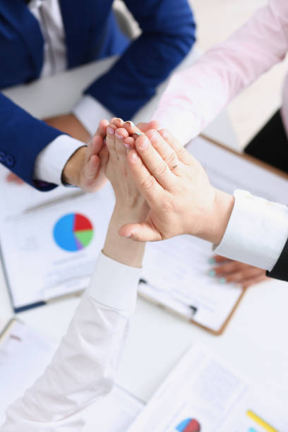 istock Group of people in suits crossed hands 940905740