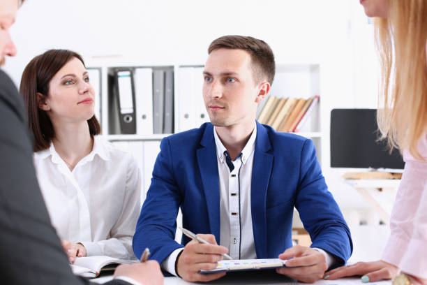 istock Group of people sit in office deliberate 940905788
