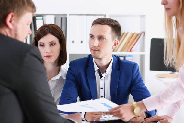 istock Group of people sit in office deliberate 940905806