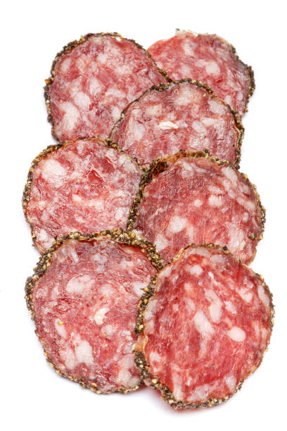 istock Dried organic salami sausage covered with pepper on white background 940910648