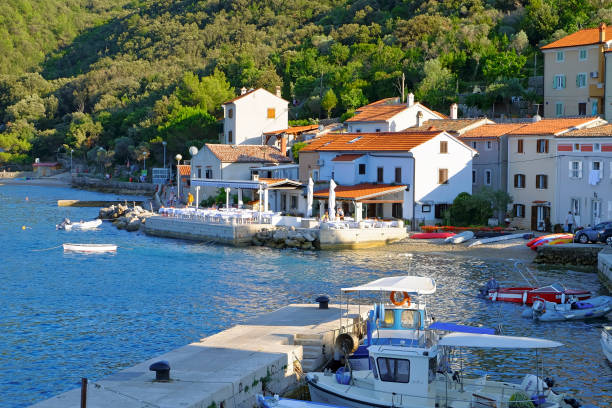 Valun, Cres Island, Croatia - July 16, 2017: View to the seafront of the small harbor in Valun. The fishing port of Valun belongs to the town of Cres on the island of Cres in the Kvarner Gulf.