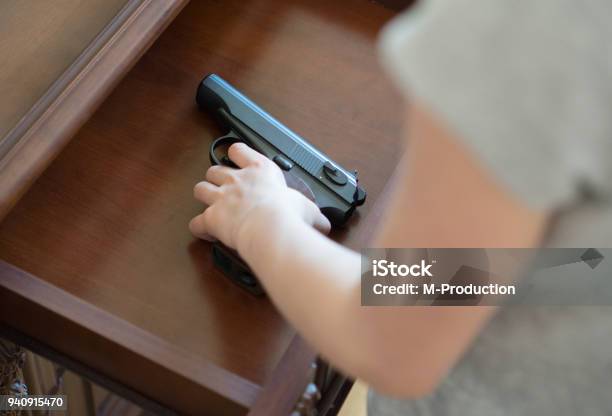 Child Found Pistol In Drawer At Home Stock Photo - Download Image Now - Gun, Child, Safety