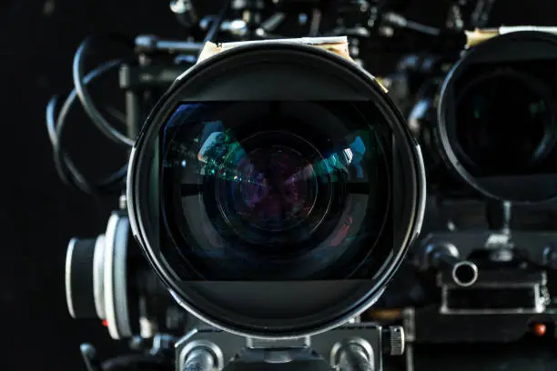 Photo of Close up shot of cinema lens with lot of equipment for filming cinema or movie in a division filming. Cinema lens. Photo lens.