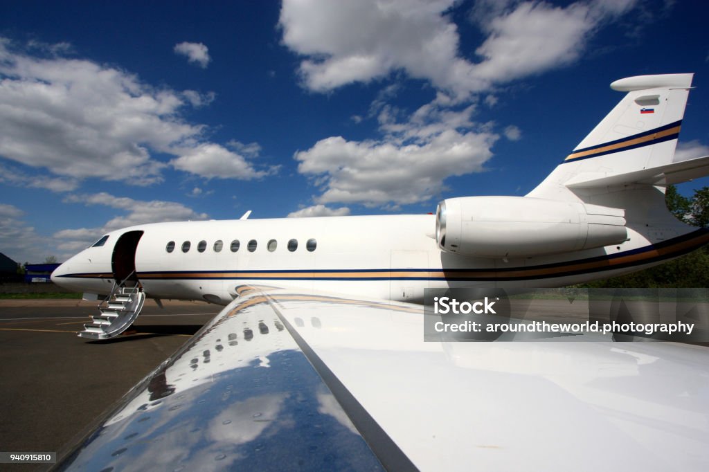 Falcon Business Jet Ready to Go A Falcon 2000 Business Jet is fully prepared and waiting for passengers in St. Petersburg, Russia. Commercial Airplane Stock Photo