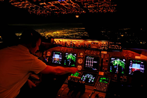 Flight Deck of a Boeing 747-400 Above NYC The American made Boeing 747-400 "Jumbo Jet" features a modern EFIS (Electronic Flight Information System) flight deck and a lot of automation, which allows companies around the world to crew this aircraft with two pilots only. 
When this picture was made, the captain started to prepare the approach and landing into Atlanta Hartsfield just minutes ago. 
Inflight overhead the United States, in the background the lights of New York City are visible (out of focus). flight instruments stock pictures, royalty-free photos & images