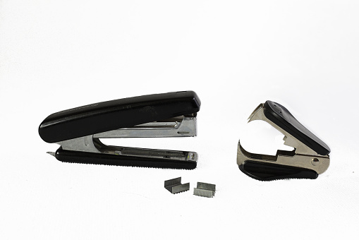 Stapler and anti-stapler on white background