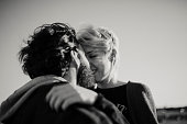 Close up portrait of couple kissing outdoors in black and white.