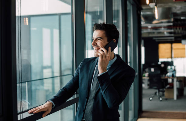istock Smiling businessman taling on phone 940923372