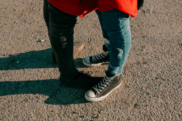 istock Couple legs view while they embrace to each other. 940926272
