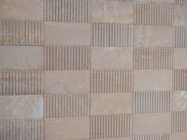 istock Interlocking paving with gray and white concrete blocks Concrete products Construction industry Paved ground 940926540