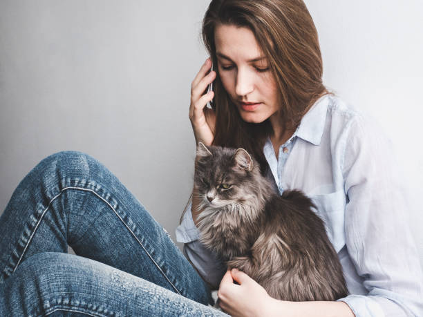 Young woman gently holding a kitten