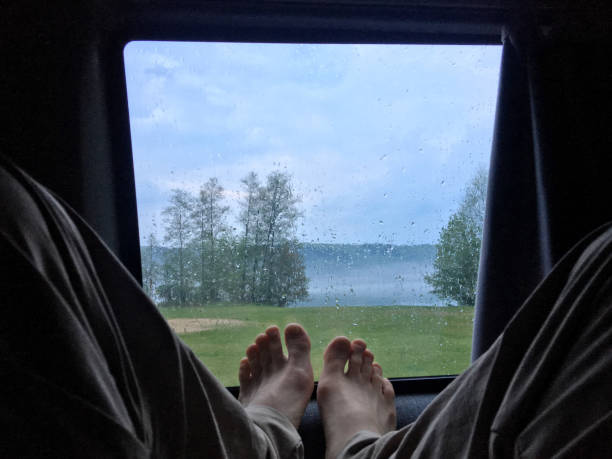 istock Chilling in the camper van during rain at the lake side. 940929780