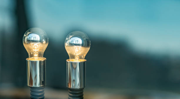 istock Two glowing lamps in a shop window - with copy space 940932624
