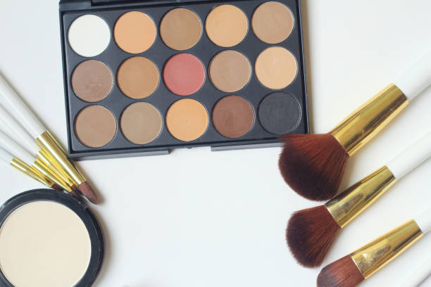 istock makeup brushes, eyeshadow and powder isolated on white background 940933510